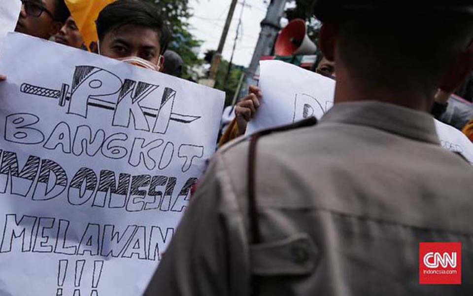 Placard reads 'The PKI is reviving in Indonesia – Fight' (CNN)