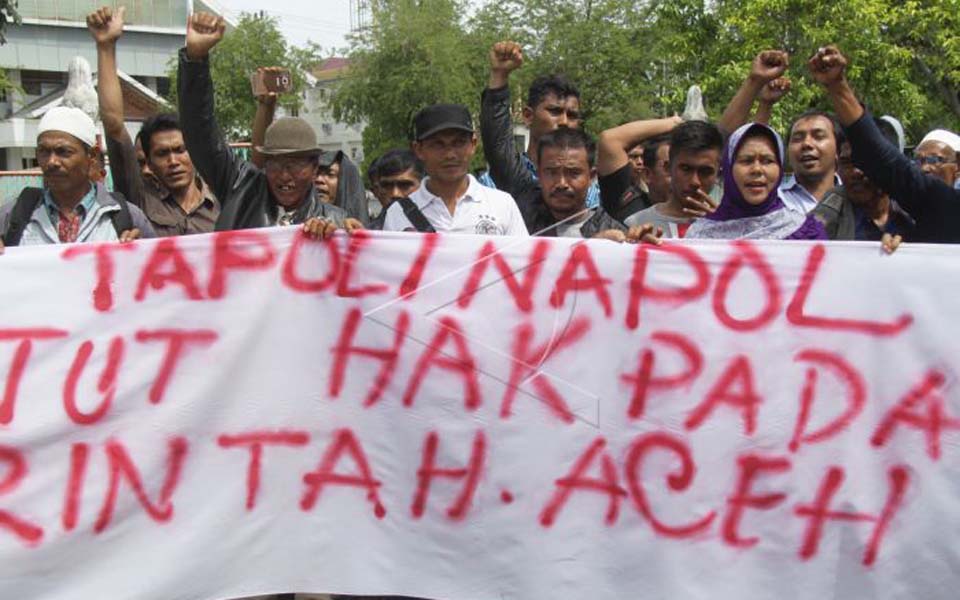 Banner reads 'Tapol Napol demand rights from government' (Antara)