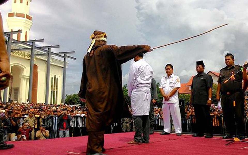 Convicted gamblers being publically flogged in Aceh (Merdeka)