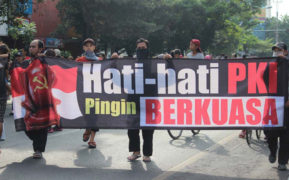 Banner reads 'Beware the PKI Wants to Take Power'