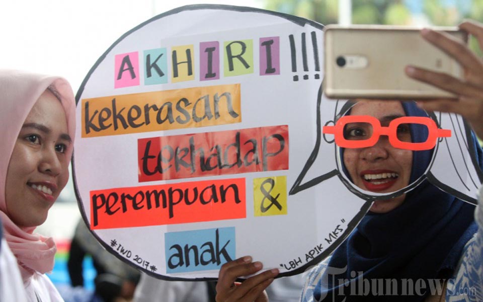 Placard reads 'End Violence against Women and Children' (Tribune)