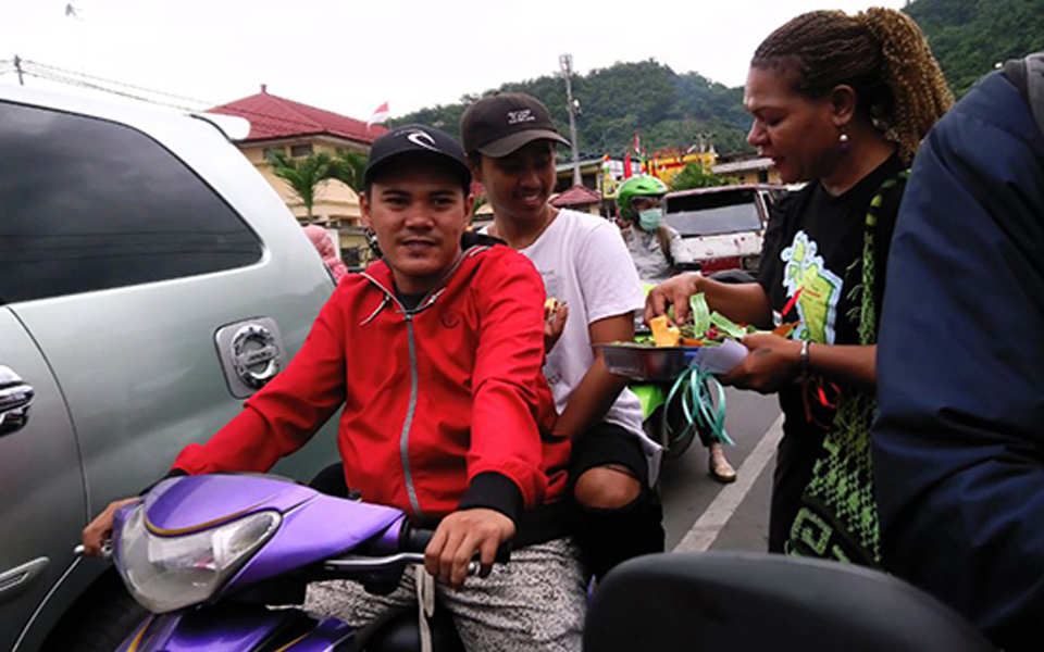 Women activists hand out flowers in Abepura - March 8, 2018 (Kabar Papua)