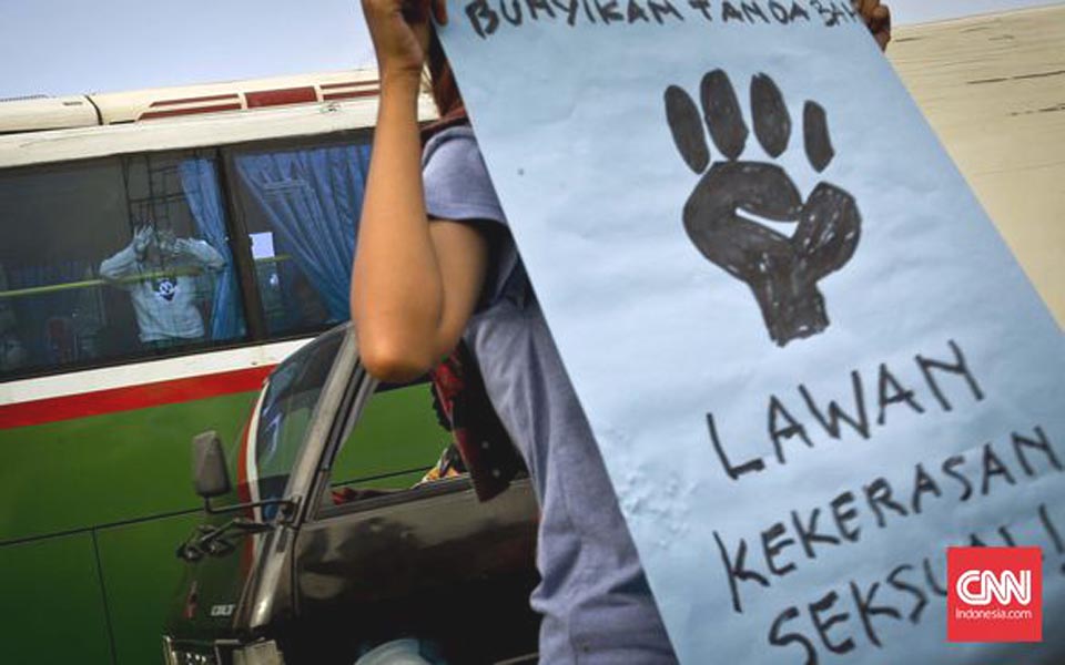 Protest banner reads 'Fight Sexual Violence' (CNN)