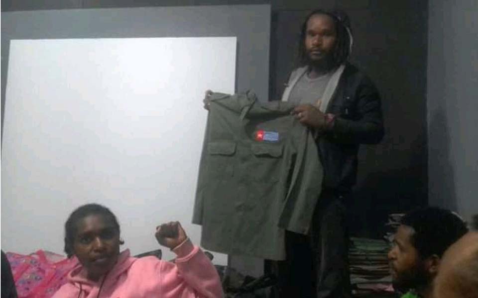 KNPB activist holding shirt with Morning Star logo (Jubi)