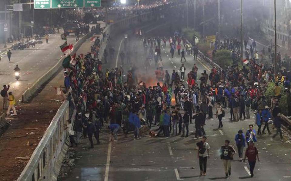 Students stand their ground against police during protest in September (CNN)